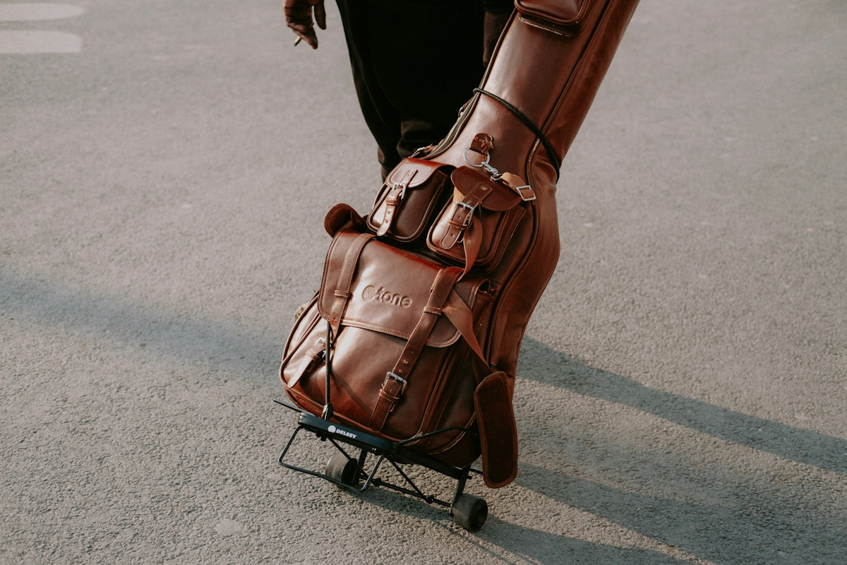 a person pushing a luggage cart down a street